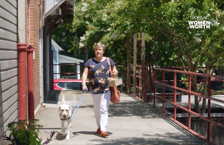 Woman walking a white dog.