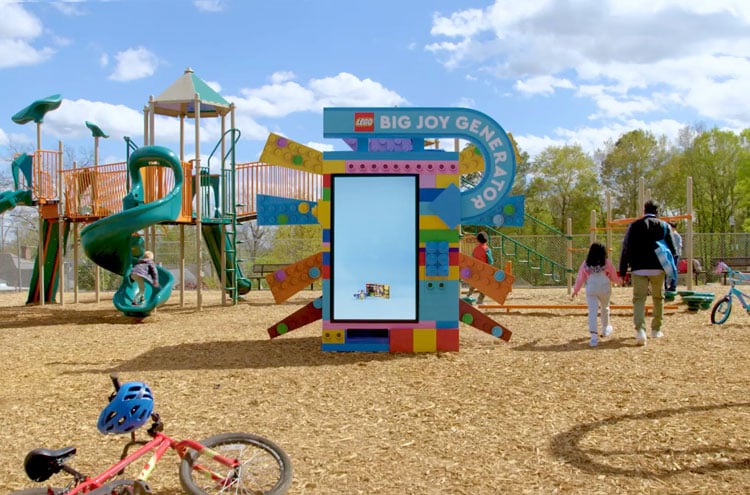 Playground with a jungle gym and a Lego Big Joy Generator sign.
